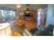 Spacious living room with hardwood floors and a wood entertainment center at 24502 Parlange Ct, Leesburg, FL 34748