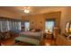 Spacious Primary bedroom with king-size bed and wood floors at 24502 Parlange Ct, Leesburg, FL 34748