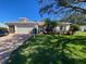 Single-Gathering home with a two-car garage and landscaped yard at 24502 Parlange Ct, Leesburg, FL 34748