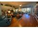 Open living room with hardwood floors and lots of natural light at 24502 Parlange Ct, Leesburg, FL 34748