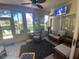 Relaxing sunroom with seating area and access to the backyard at 24502 Parlange Ct, Leesburg, FL 34748