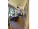 Spacious sunroom with ample seating, ceiling fan, and access to the backyard at 24502 Parlange Ct, Leesburg, FL 34748
