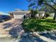 Single Gathering home with two-car garage and brick driveway at 24502 Parlange Ct, Leesburg, FL 34748