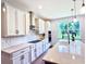 Bright kitchen featuring white cabinets, quartz countertops, and a stylish backsplash at 29912 Cypress Pointe, Deer Island, FL 32778