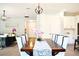 Bright dining room with a long wooden table and eight chairs, kitchen view at 29912 Cypress Pointe, Deer Island, FL 32778