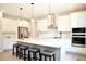 Modern kitchen with white cabinets, stainless steel appliances, and large island at 29912 Cypress Pointe, Deer Island, FL 32778