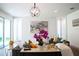 Living area with gray sofas, a large painting, and a decorative console table at 29912 Cypress Pointe, Deer Island, FL 32778