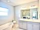 Elegant bathroom with double vanity, soaking tub, and walk-in shower at 29912 Cypress Pointe, Deer Island, FL 32778