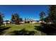 Backyard view showcasing the home's exterior, a gazebo, and grassy lawn at 9832 Sw 46Th Ct, Ocala, FL 34476