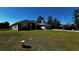 Single-story home with gray exterior, attached garage, and a well-manicured lawn at 9832 Sw 46Th Ct, Ocala, FL 34476