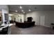 Spacious living room with neutral carpeting and a large TV at 9832 Sw 46Th Ct, Ocala, FL 34476