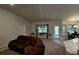Comfortable living room with a brown sectional sofa and access to a backyard at 9832 Sw 46Th Ct, Ocala, FL 34476