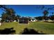 Large backyard with gazebo, showing the back of the house and green space at 9832 Sw 46Th Ct, Ocala, FL 34476