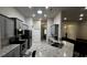 Modern kitchen with gray cabinets, granite countertops, and stainless steel appliances at 9832 Sw 46Th Ct, Ocala, FL 34476
