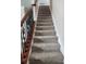 Indoor stairway with wood railing and carpeted steps leading to upper level at 348 Magneta Loop, Auburndale, FL 33823