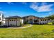 Modern single story home with landscaped lawn and walkway at 6006 Abbey Oaks Dr, Lakeland, FL 33811