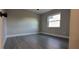 Bright bedroom featuring wood-look floors and a window at 2469 Courtland Blvd, Deltona, FL 32738