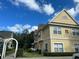 Two-story townhouses with inviting landscaping and a walkway at 4005 Santa Maria Dr # 103, Kissimmee, FL 34741