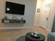 Cozy living room with a large TV, comfortable seating, and a convenient coffee table at 4005 Santa Maria Dr # 103, Kissimmee, FL 34741