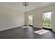 Spacious bedroom with dark hardwood floors and French doors leading to a balcony at 1250 S Pennsylvania Ave # 8, Winter Park, FL 32789