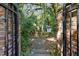 Brick gate entrance to a lush, private garden area at 1250 S Pennsylvania Ave # 8, Winter Park, FL 32789