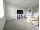 Bonus room with neutral walls, carpeting, and a large TV at 2905 Black Birch Dr, Ocoee, FL 34761