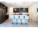 Modern kitchen with dark cabinetry, quartz countertops, and island with seating at 2905 Black Birch Dr, Ocoee, FL 34761