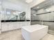 Bathroom with soaking tub, walk-in shower, and double vanity at 550 Muirfield Loop, Reunion, FL 34747