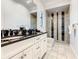 Bathroom with double vanity, black countertop, and shower at 550 Muirfield Loop, Reunion, FL 34747