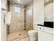 Modern bathroom with glass shower, tile flooring and a white vanity at 550 Muirfield Loop, Reunion, FL 34747