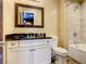 Bathroom with a white vanity, bathtub, and shower at 550 Muirfield Loop, Reunion, FL 34747