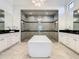 Spa-like bathroom with a large soaking tub and walk-in shower at 550 Muirfield Loop, Reunion, FL 34747