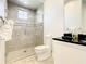 Bathroom with shower, toilet and modern vanity at 550 Muirfield Loop, Reunion, FL 34747