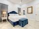 Blue bedroom with a king-size bed and en-suite bathroom at 550 Muirfield Loop, Reunion, FL 34747