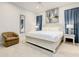 Bedroom with king-size bed, light walls, and blue accents at 550 Muirfield Loop, Reunion, FL 34747