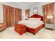 Bedroom with a king-size bed and orange accents at 550 Muirfield Loop, Reunion, FL 34747