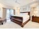 Bedroom with king-size bed and balcony access at 550 Muirfield Loop, Reunion, FL 34747