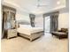 Main bedroom with king-size bed and sitting area at 550 Muirfield Loop, Reunion, FL 34747