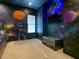 Space-themed bedroom with a bunk bed, TV and decor at 550 Muirfield Loop, Reunion, FL 34747