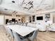 Elegant dining room with marble table, gray chairs, and modern lighting at 550 Muirfield Loop, Reunion, FL 34747