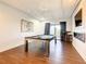 Game room with pool table, fireplace and access to balcony at 550 Muirfield Loop, Reunion, FL 34747
