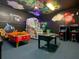 Game room with air hockey, foosball, and arcade games at 550 Muirfield Loop, Reunion, FL 34747