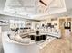 Open floor plan great room with high ceilings, stylish furniture, and large windows at 550 Muirfield Loop, Reunion, FL 34747