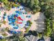 Circular pool with water features and sandy beach at 550 Muirfield Loop, Reunion, FL 34747