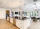 Open concept kitchen with large island, stainless steel appliances, and hardwood floors at 550 Muirfield Loop, Reunion, FL 34747