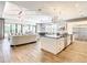 Modern kitchen island with white cabinets, granite countertops, and stainless steel appliances at 550 Muirfield Loop, Reunion, FL 34747