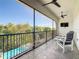 Relaxing screened balcony overlooking the pool and backyard at 550 Muirfield Loop, Reunion, FL 34747