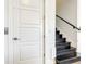 Modern staircase with black wood steps and white walls at 550 Muirfield Loop, Reunion, FL 34747