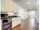 Modern wet bar with white cabinets and black countertops at 550 Muirfield Loop, Reunion, FL 34747