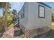 Home's exterior showcasing a light blue metal structure and wooden skirting at 18925 3Rd Ave, Orlando, FL 32820